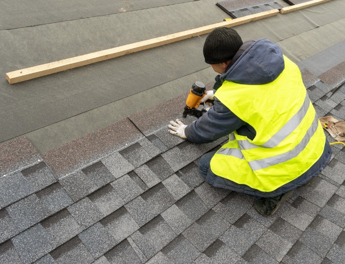 A qualified roofer installing new residential roofing in Central Illinois
