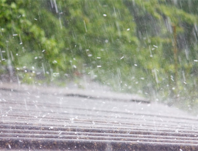Hail pelting the top of a roof, causing Storm Damage in Central Illinois